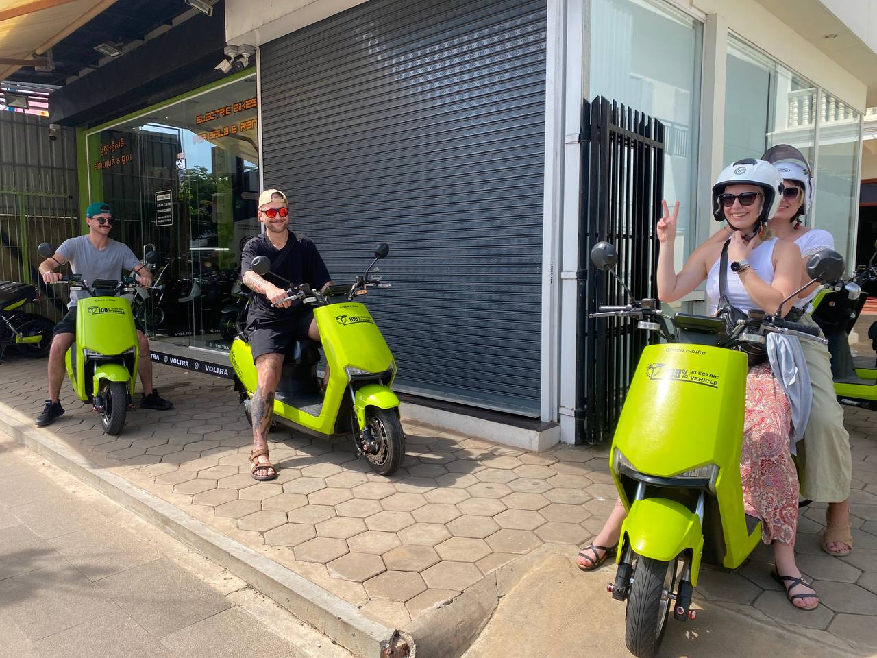 Customers with Green e-bike vehicles near temple area